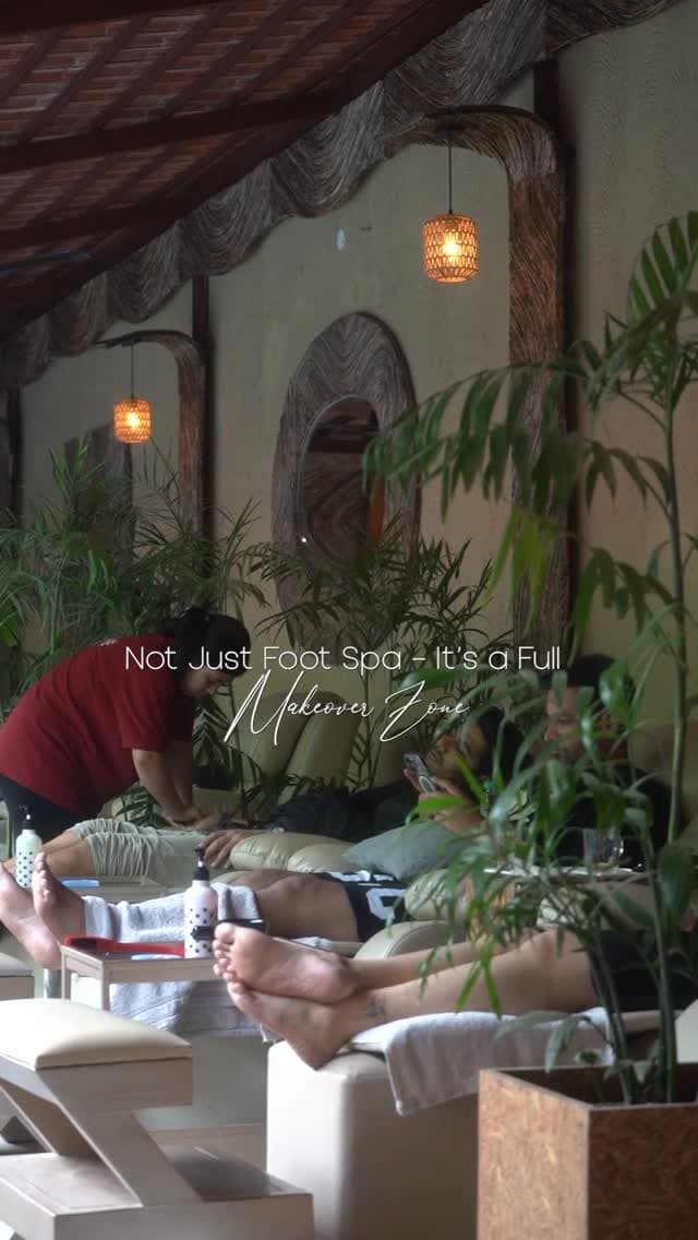 Guests reclining among the plants and lantern light of the patio